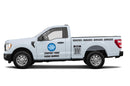 A white pickup truck featuring custom vinyl lettering decals, a business logo, and a QR code on its sides.